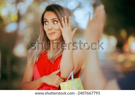 
Person Pretending Not to See Someone Waving and Saluting 
Woman disregarding a friendly greeting after recognizing an annoying acquaintance 
 Royalty-Free Stock Photo #2407667795