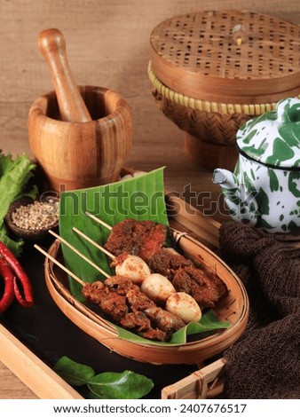 Sate Usus, Sate Telur Puyuh, Sate Kerang and sate jengkol. Skewered food dish of chicken intestine, quail eggs, and cockles. Popular side dishes in Javanese meals. Served on woven bamboo plate.
 Royalty-Free Stock Photo #2407676517