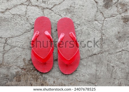 red flip-flops are on the terrace of the house
