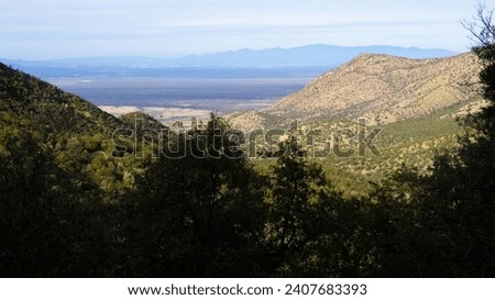 View of the Arizona towns of Tucson, Sahuarita, and Green Valley from Madera Canyon, in the Santa Rita Mountains, in Pima County, with the Santa Catalina Mountains in the distance, New Years Eve 2024. Royalty-Free Stock Photo #2407683393
