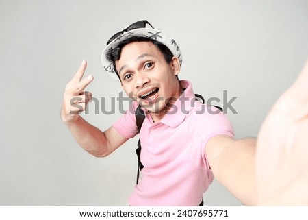 Asian man backpacker taking selfie photos. digital nomad and travelling concept. on isolated background