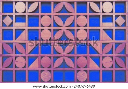 In the picture is an art picture from cutting a wooden floor into shapes. In the picture is an art picture from cutting a wood floor into shapes such as circles, squares, triangles, and elongated oval