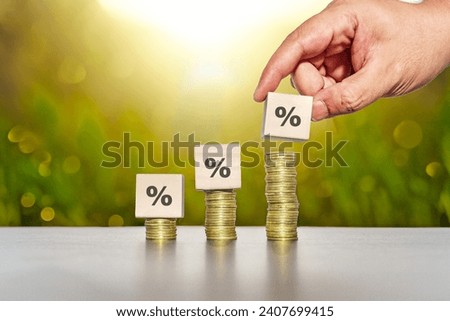 Hand picked percentage sign on wooden cubes. Stacking for interest rate and business profit growth concept. 