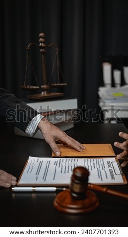Businessman or lawyer discussing contract or business agreement at law office Justice service concept with hammer and goddess of justice beside vertical image, close-up