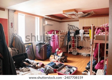 super messy dorm room with bunkbeds Royalty-Free Stock Photo #2407708159