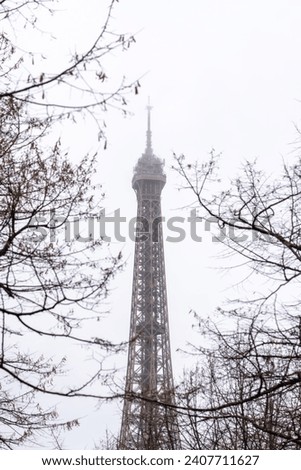 Then Eiffel in Paris in the park whit trees Royalty-Free Stock Photo #2407711627