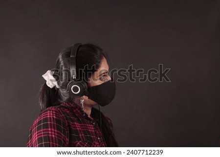  Indian woman wearing a Black face mask, Side view picture