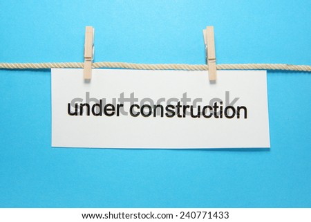 hanging under construction sign