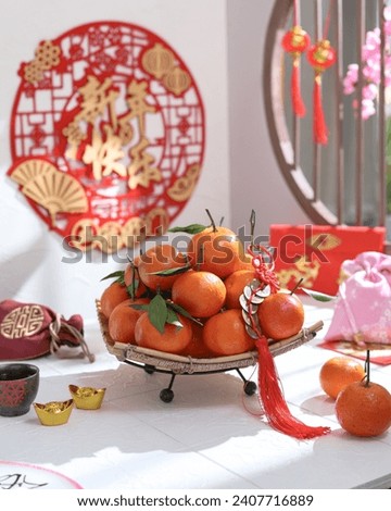 Chinese character "Xi Nian Kuai Le" means Happy New Year.
Selective focus of table conceptual tangerines or mandarin oranges for Lunar New Year.