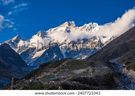View of Kedarnath mountain from Kedarnath Temple hiking trail, dedicated to Lord Shiva located at 3584m in Uttarakhand and it is a part of Char Dhams, Panch Kedar and 12 Jyotirlingas. Royalty-Free Stock Photo #2407723343