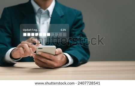 Businessman installing update process on smartphone. Software updates or operating system upgrades to keep your device up to date with enhanced functionality in new versions and improved security.