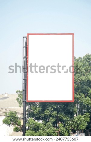 Blank vertical billboard hanging on pole near street. Background for mock up.