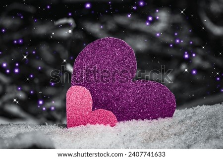 Two shiny hearts stand in the snow and symbolize love, loyalty, devotion. Banner, place for your text. Sequins, glitter on the background. Winter. snow, ice, cold season. Background for February 14.