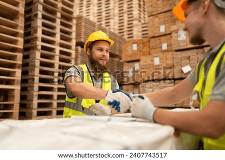 Caucasian businessman working with stock timber background at wood factory