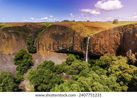Phantom Waterfall dropping off over vertical basalt walls, North Table Mountain Ecological Reserve, Oroville, California Royalty-Free Stock Photo #2407751231