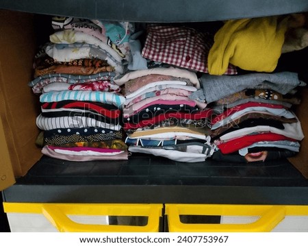 piles of clothes in a black box