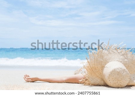 Woman lies on the white sand on the beach. Summer and vacation concept