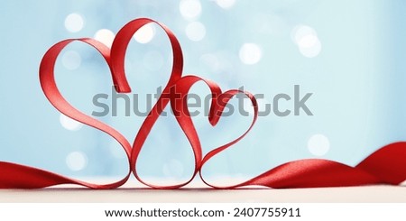 Hearts made from red ribbon. Valentine's card.