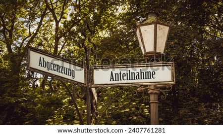 An image with a signpost pointing in two different directions in German. One direction points towards participation, the other points towards differentiation. Royalty-Free Stock Photo #2407761281