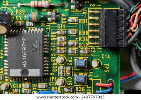 Detail of old electronic components of a motherboard with its chips, capacitors and solders Royalty-Free Stock Photo #2407797015