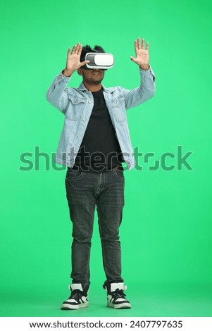 full-length man on a green background wearing 3D augmented reality glasses