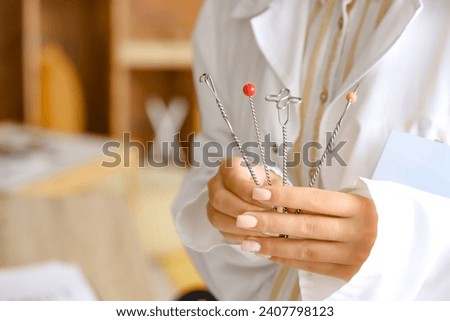 Female speech therapist with logopedic probes in office, closeup Royalty-Free Stock Photo #2407798123