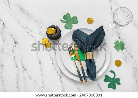 Beautiful table setting for St. Patrick's Day celebration on white marble background
