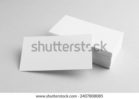 Blank business cards on light grey background. Mockup for design