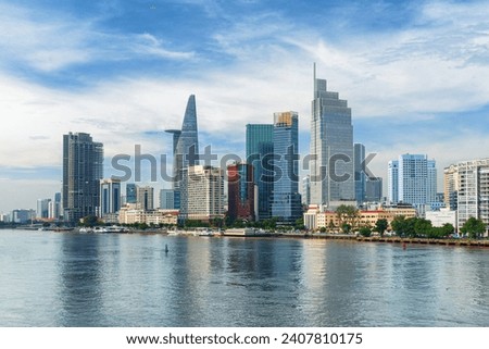 Awesome Ho Chi Minh City skyline. Amazing view of skyscrapers and other high-rise buildings reflected in water of the Saigon River at downtown of Ho Chi Minh City, Vietnam. Scenic cityscape.