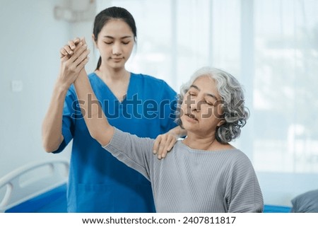 senior woman doing exercise at clinic with physiotherapist. help of a personal trainer during a rehabilitation session.