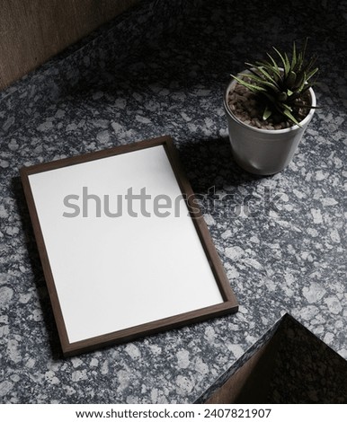simple elegant wooden frame mockup poster laying  on the luxury marble kitchen