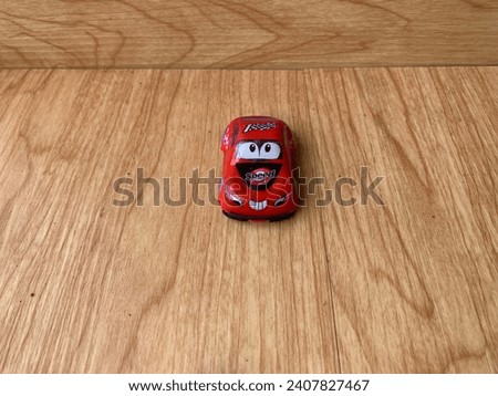 Colorful Toy Cars on Rustic Wooden Board Background