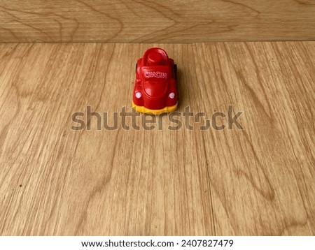 Colorful Toy Cars on Rustic Wooden Board Background