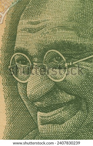 Closeup of the image of Mahatma Gandhi on Indian Currency Notes. Royalty-Free Stock Photo #2407830239