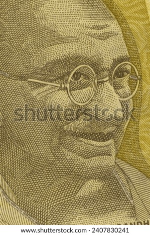 Closeup of the image of Mahatma Gandhi on Indian Currency Notes. Royalty-Free Stock Photo #2407830241