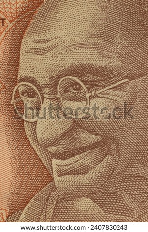 Closeup of the image of Mahatma Gandhi on Indian Currency Notes. Royalty-Free Stock Photo #2407830243