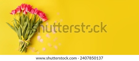 Pink colorful Holiday banner. Bouquet of pink tulips on yellow background. Mother's day, Valentines Day, Birthday, Wedding celebration concept. Hello Spring, Copy space, top view, greeting card banner