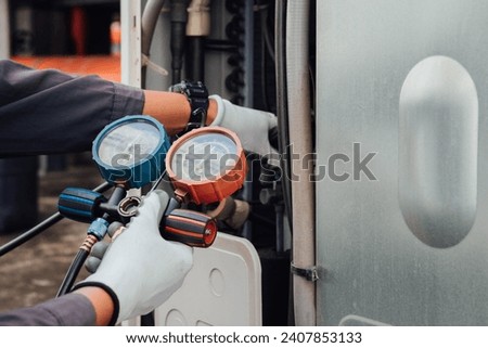 air conditioner ,measuring equipment for filling air conditioners. Royalty-Free Stock Photo #2407853133