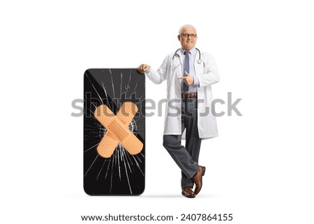 Doctor pointing at a broken screen on a smartphone fixed with a bandage isolated on white background