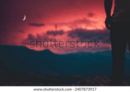 A sunset picture of mountains and moon
