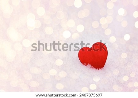 February 14 postcard,  red heart on the snow among blurry lights, space for text,