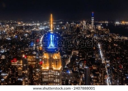 Aerial View of Midtown Manhattan Architecture at Night. Evening Photo of Financial Business District from a Helicopter. Scenery of Historic Office Towers, Including Illuminated Empire State Building
