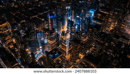 New York Concrete Jungle at Night. Aerial Photo from a Helicopter Tour Around the Center of the Big Apple. Scenes with Times Square District with Crowds of Tourists Enjoying Manhattan Nightlife Royalty-Free Stock Photo #2407888103
