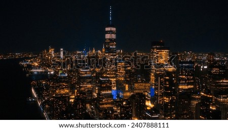 Night Aerial Photo with the One World Trade Center Skyscraper with Lights in Office Rooms Inside. Helicopter Flying Close to the Building with a View on New York City
