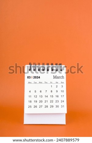 Vertical of March 2024 table calendar on orange color background.