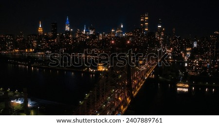 Aerial Helicopter Photo Over Ed Koch Queensboro Bridge with Manhattan Skyscrapers Cityscape. Beautiful Late Evening Shot Focusing on Upper East Side Office Buildings at Night