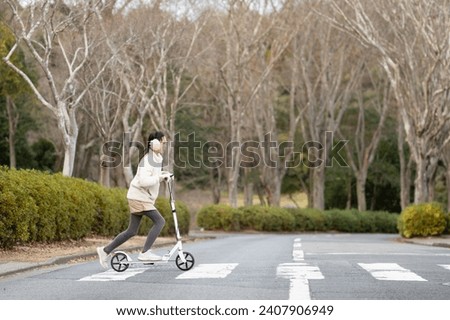 child playing with kick skater Royalty-Free Stock Photo #2407906949