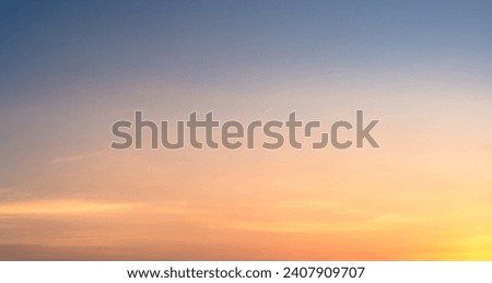 Golden Hour sunset sky in the evening with orange, yellow  sunlight, Horizon sky Background  Royalty-Free Stock Photo #2407909707