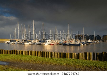Amble Marina at the Harbour. Amble Harbour is actually called Warkworth Harbour and is set on the banks of the River Coquet in Northumberland in the North East of England Royalty-Free Stock Photo #2407924767