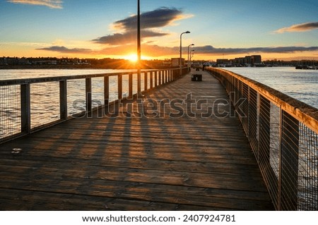 Sunset above Amble from South Jetty. Amble Harbour is actually called Warkworth Harbour and is set on the banks of the River Coquet in Northumberland in the North East of England Royalty-Free Stock Photo #2407924781